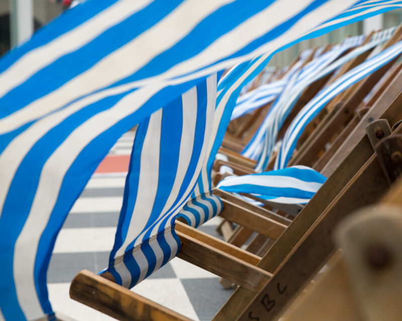 Scarborough Spa wedding photography – striped deckchairs by the seafront in the wind