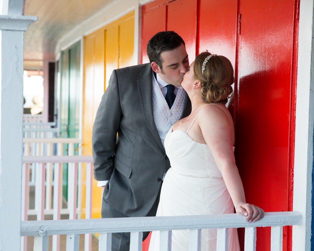Scarborough Spa wedding photography – couple portrait near the beach cabins at Scarborough Spa in soft sunlight